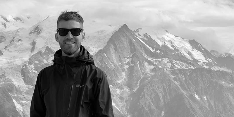 Filmmaker with a mountain backdrop